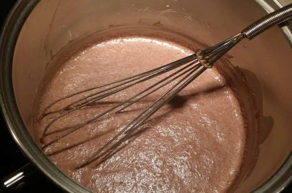 whisking ingredients for homemade chocolate pudding