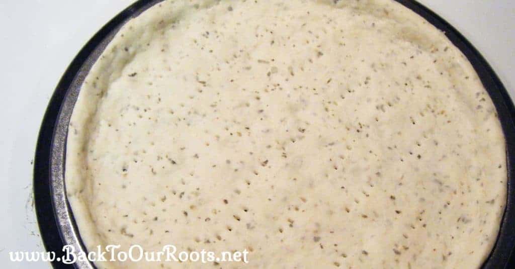 Italian Herb & Cheese Pizza crust pricked and ready for the oven