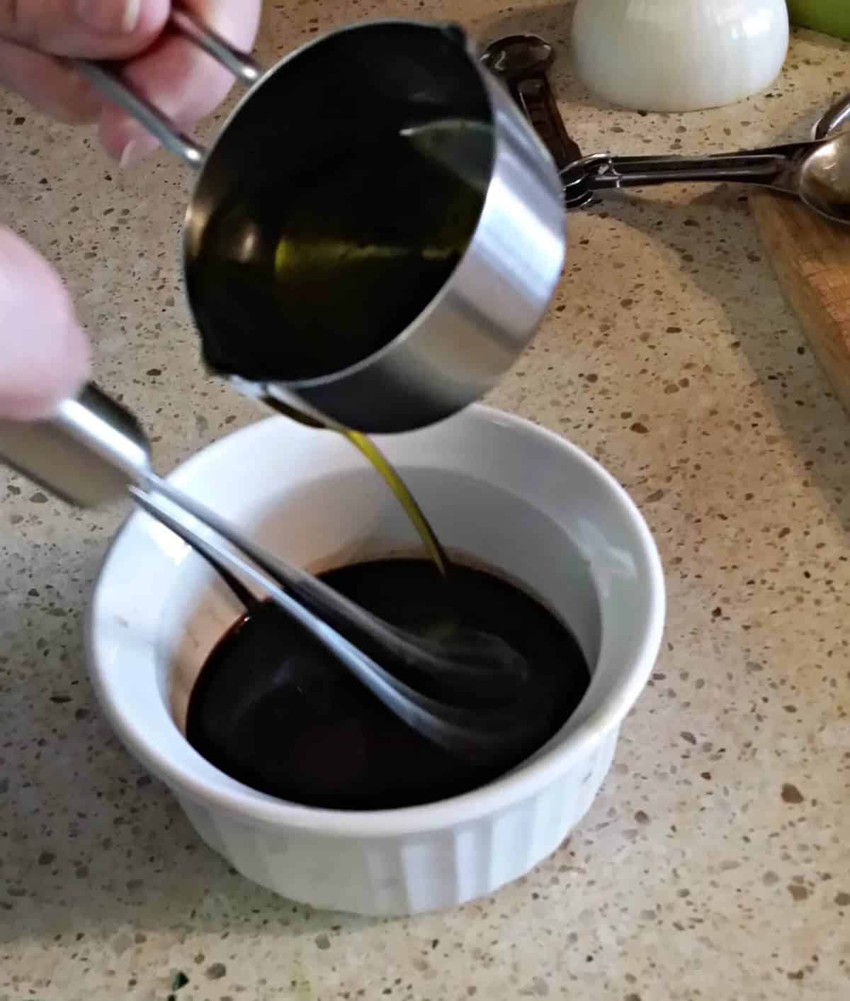 whisking in the olive oil to the vinaigrette for steamed asparagus
