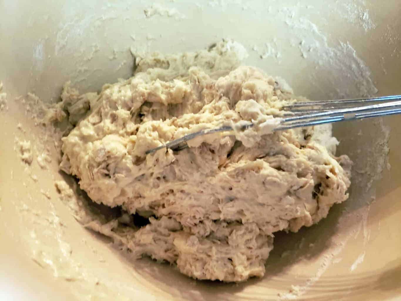 sourdough soda bread dough in bowl with whisk