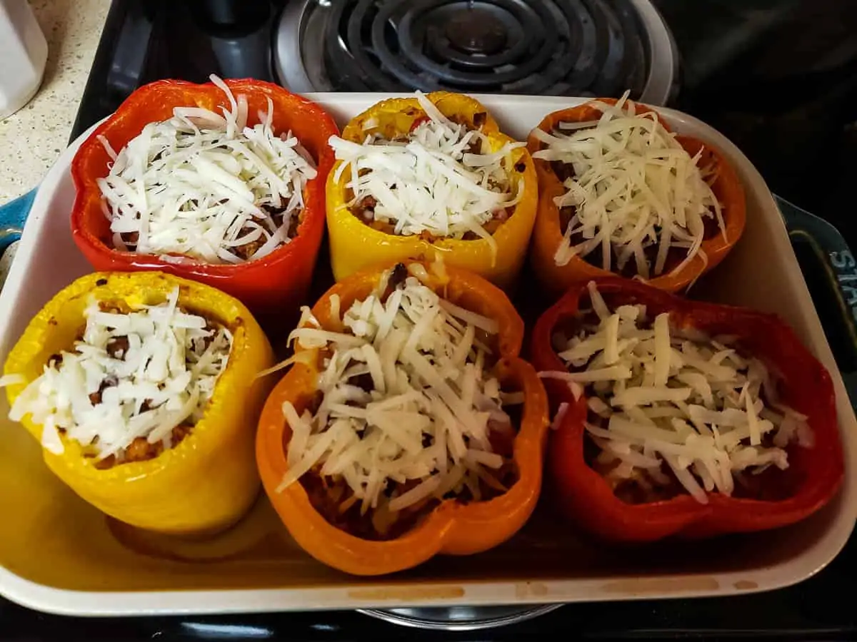 shredded cheese on top of stuffed bell peppers