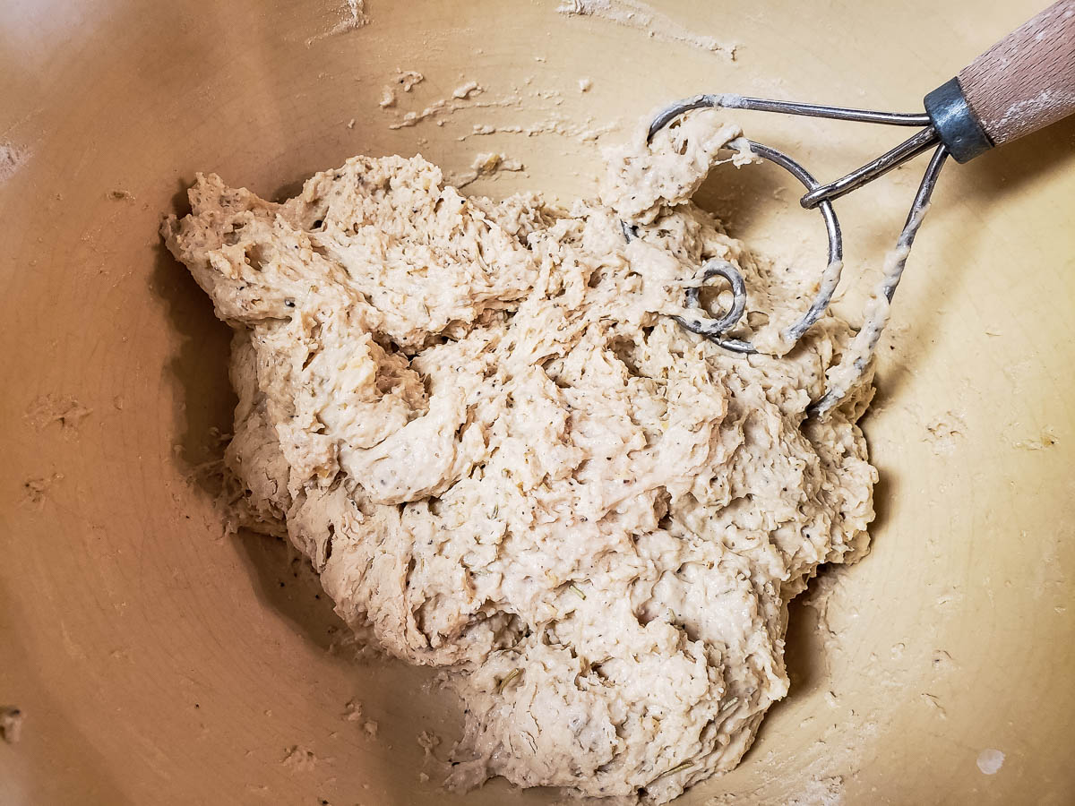 Parmesan Rosemary Breadstick dough in bowl with dough whisk