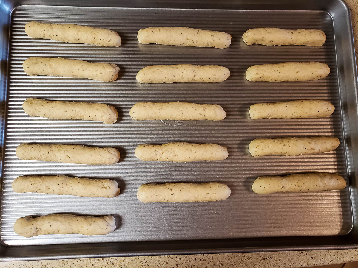 Unbaked Parmesan Rosemary Breadsticks on baking sheet